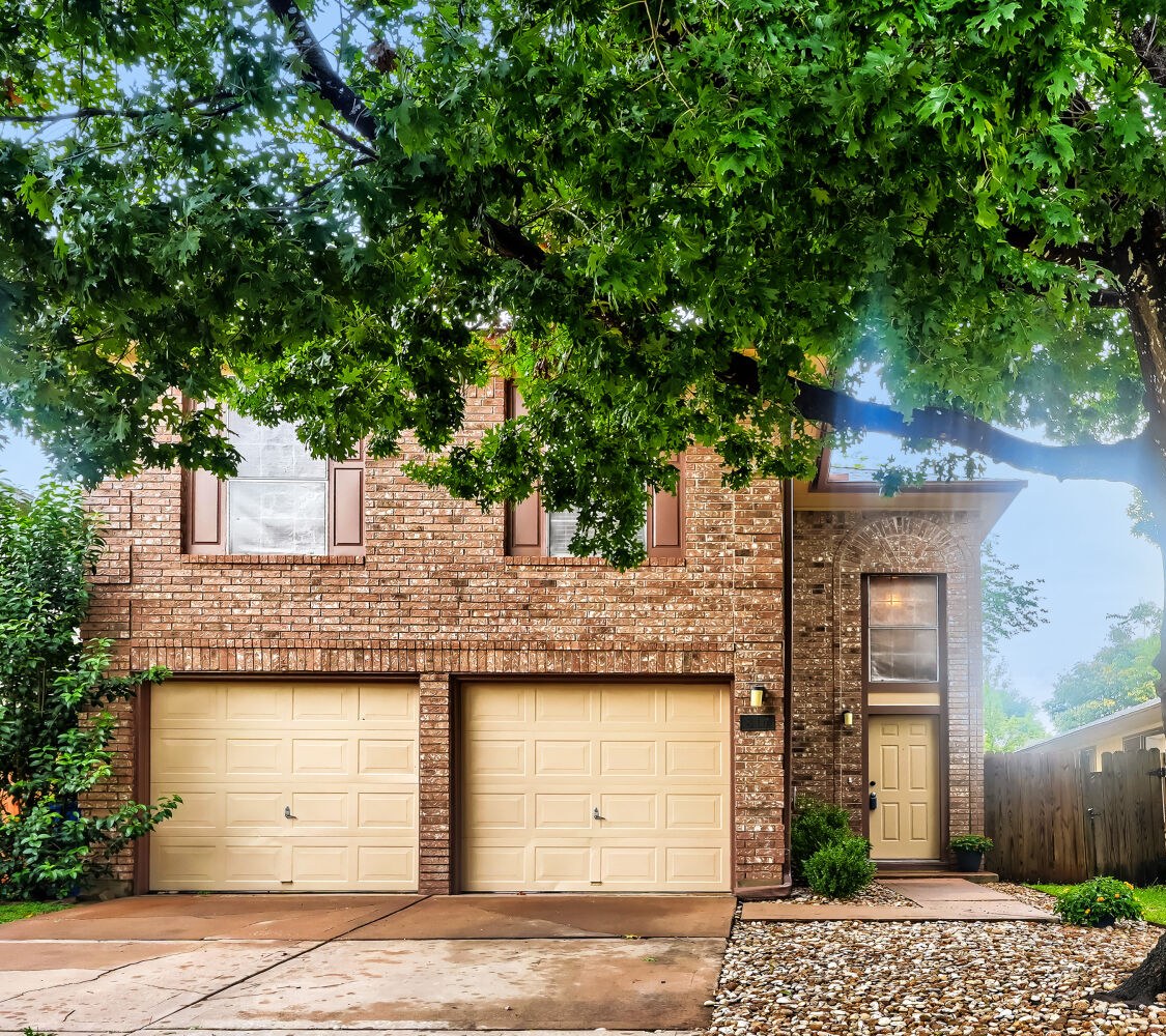 Front exterior with mature shade tree